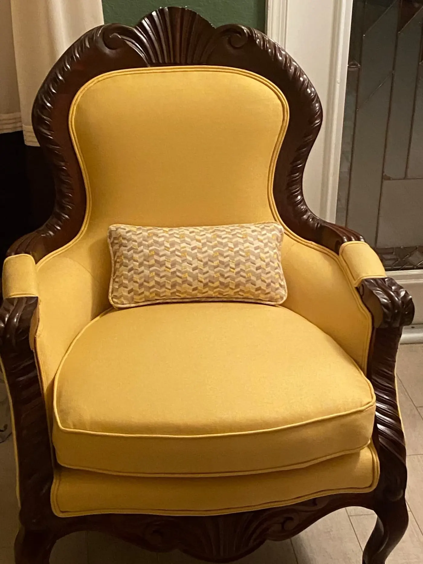 Carved wood armchair reupholstered in yellow fabric