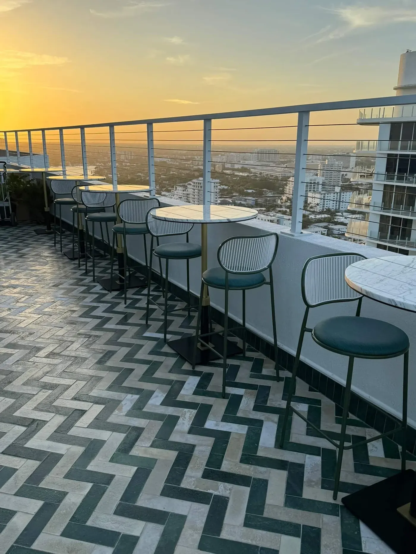Rooftop terrace bar seating overlooking Miami