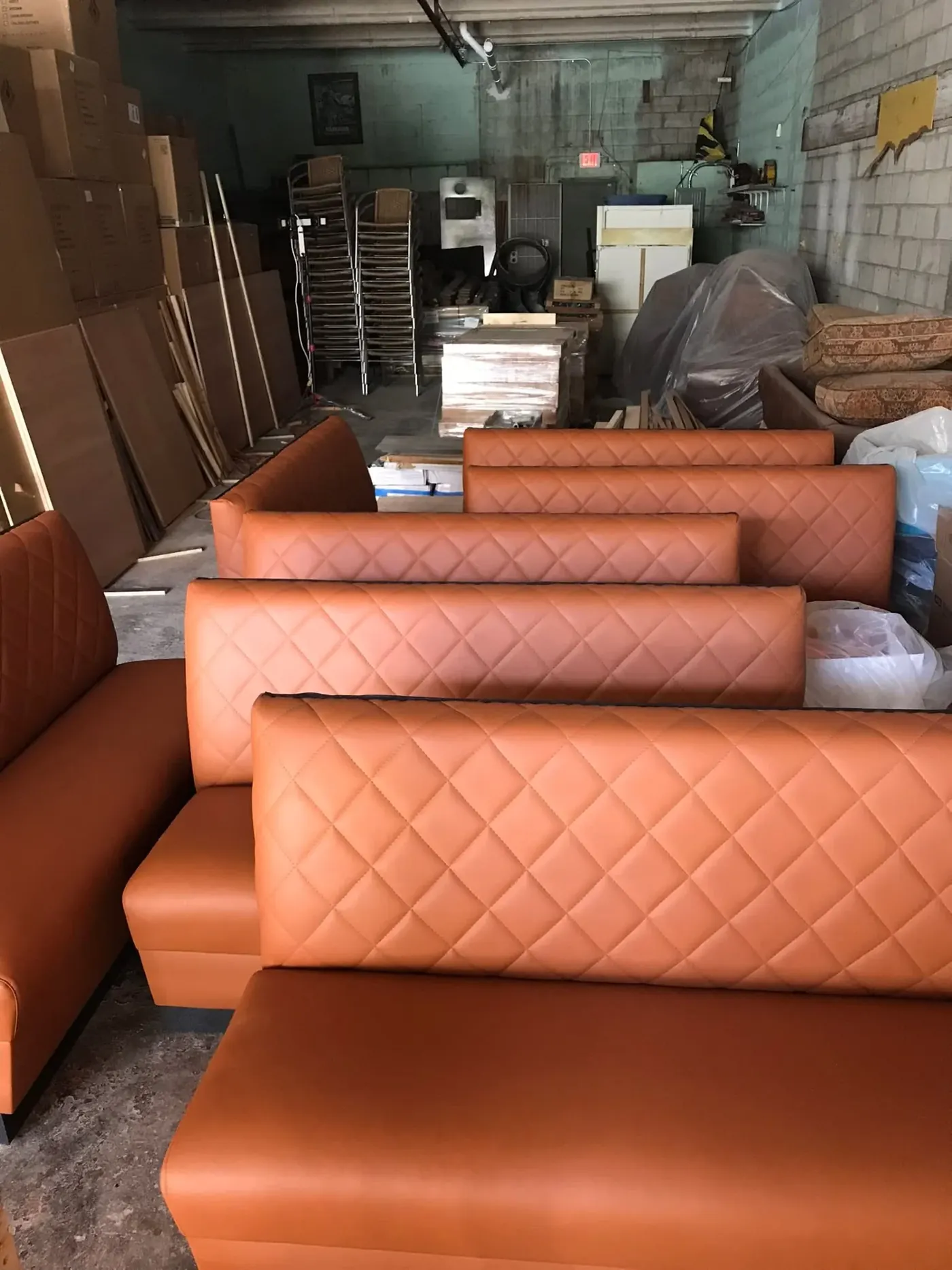 Diamond-stitched orange booth seating in the workshop