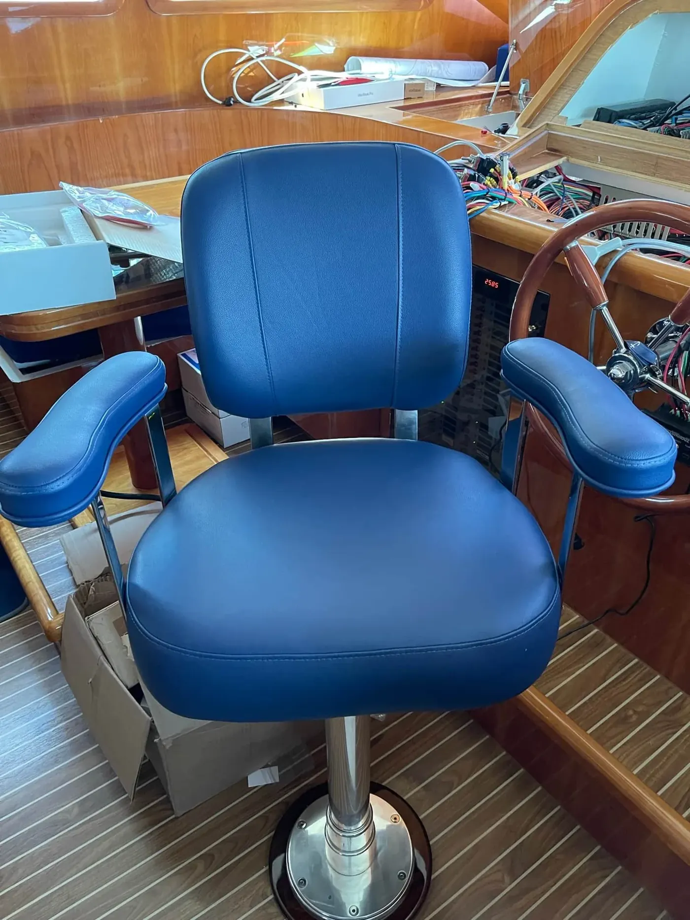 Blue marine-vinyl helm chair on a boat