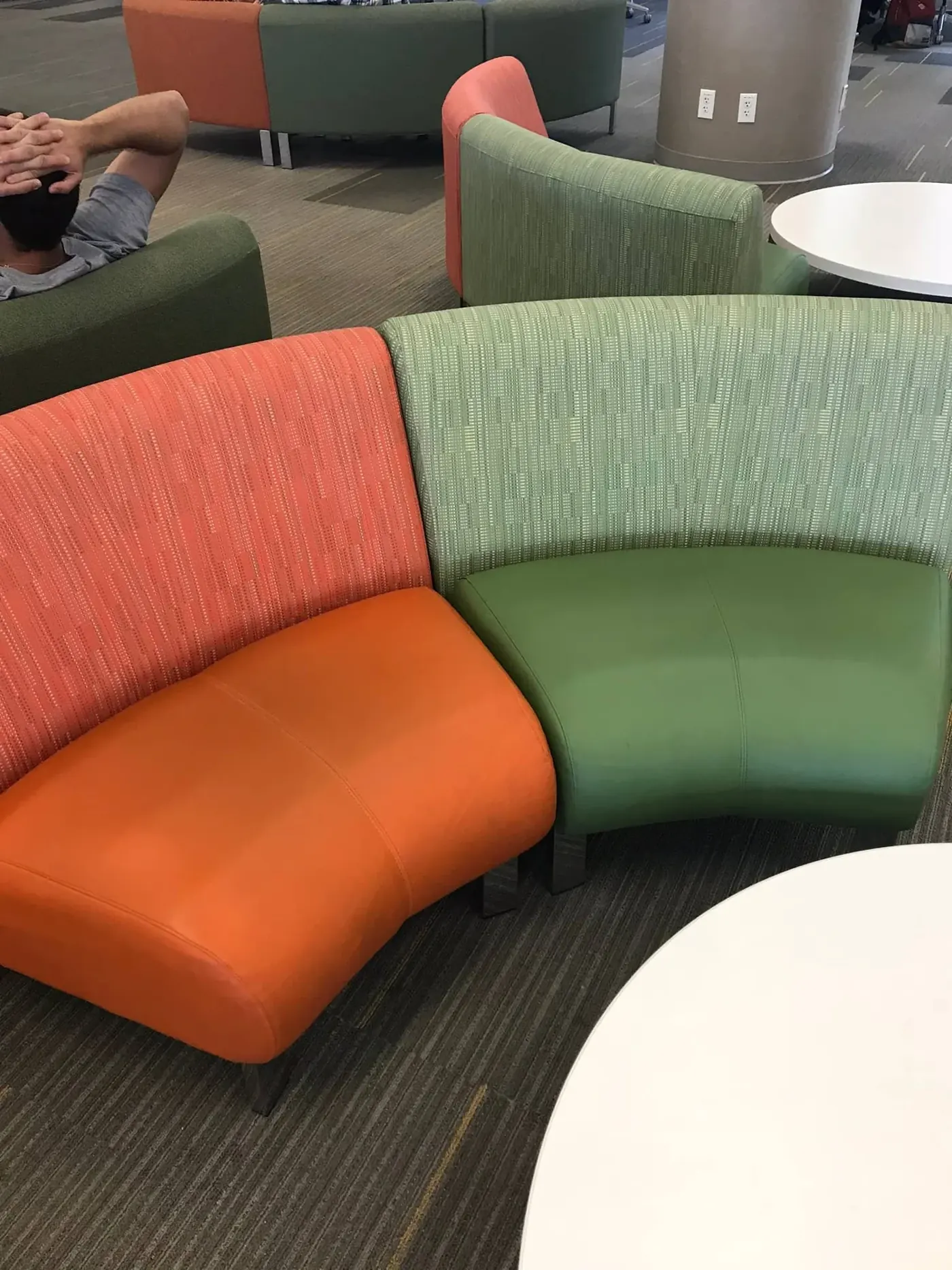 Curved commercial lounge seating in orange and green